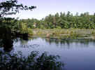 View of a house from the pond dam (109KB)